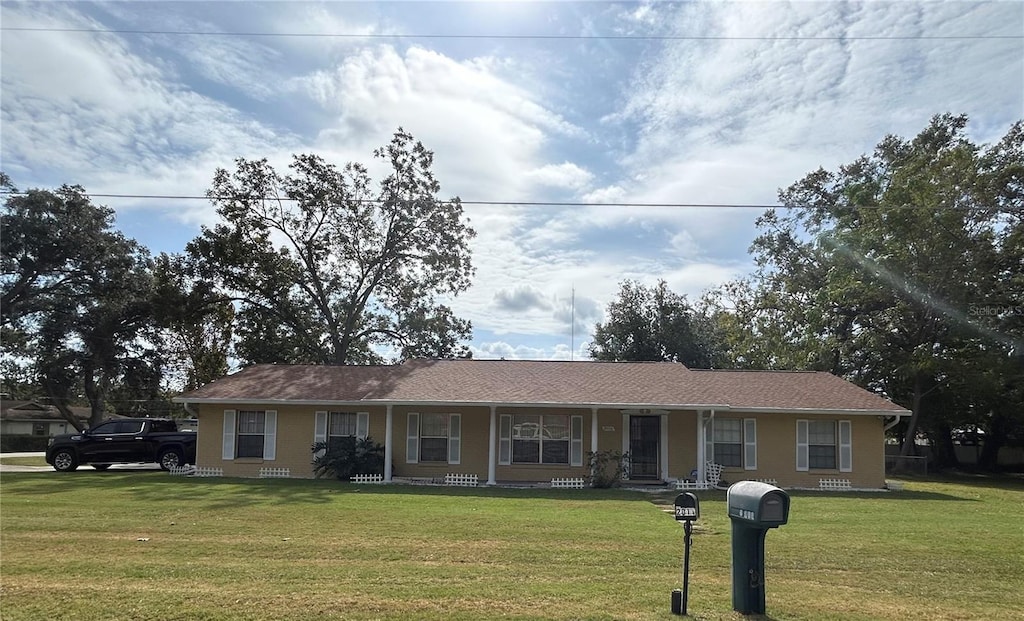 ranch-style home with a front yard