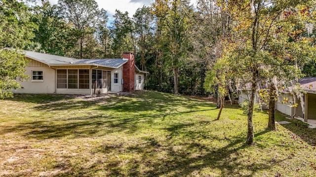 view of yard featuring a sunroom