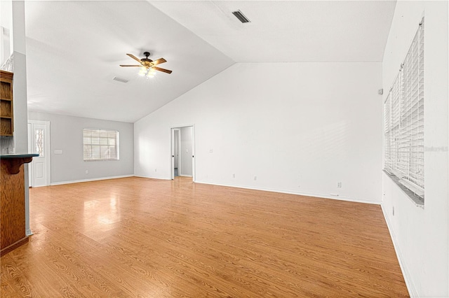 unfurnished living room featuring ceiling fan, vaulted ceiling, and light hardwood / wood-style flooring