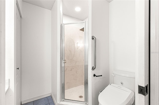 bathroom featuring tile patterned floors, a shower with door, and toilet