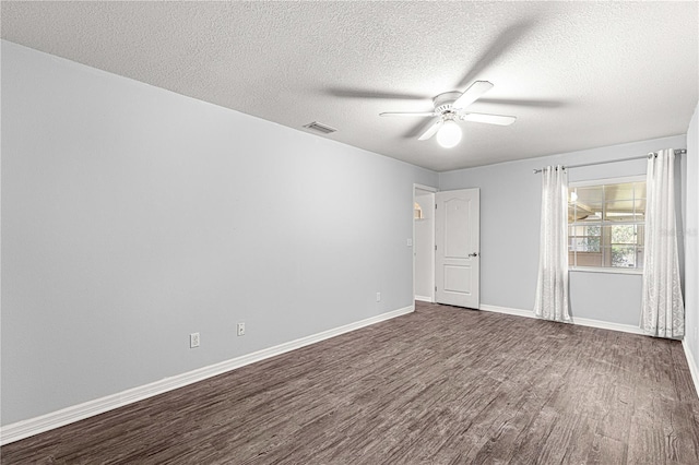 unfurnished room with ceiling fan, dark wood-type flooring, and a textured ceiling