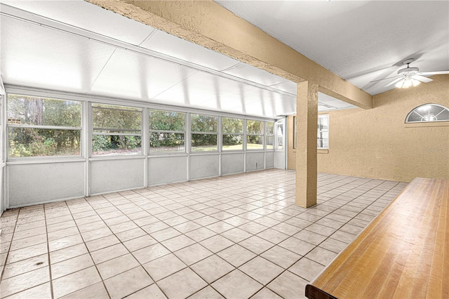 unfurnished sunroom with ceiling fan