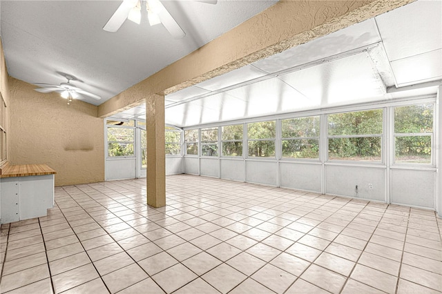 unfurnished sunroom featuring ceiling fan