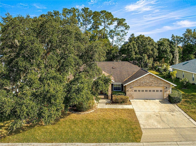 view of front of home with a garage and a front yard