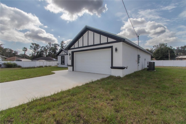 view of side of property featuring central AC, a yard, and a garage