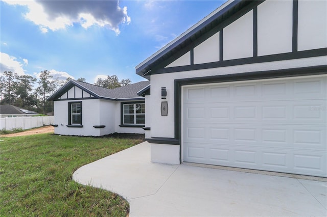 view of front of home featuring a front yard and a garage