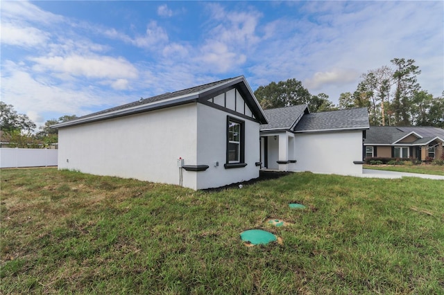 view of side of property with a lawn