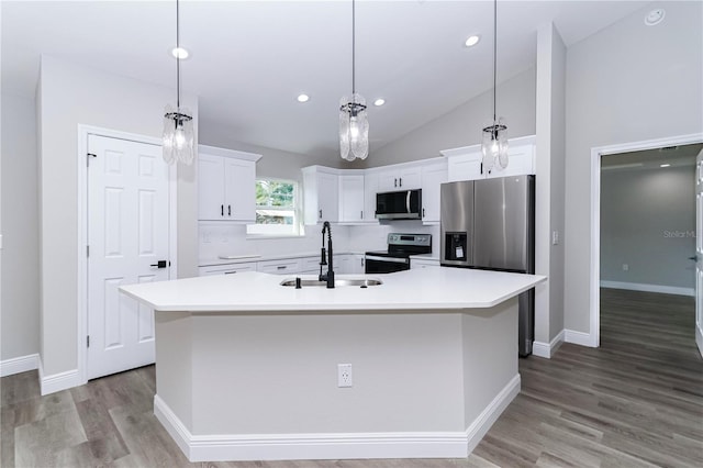 kitchen with sink, white cabinetry, stainless steel appliances, and a kitchen island with sink