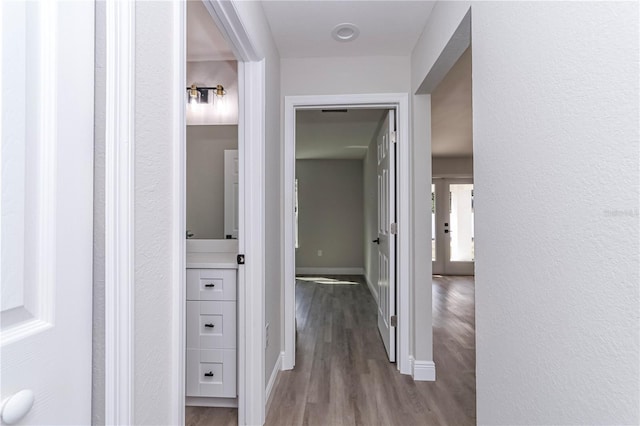 corridor with wood-type flooring