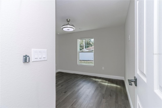 empty room with dark wood-type flooring