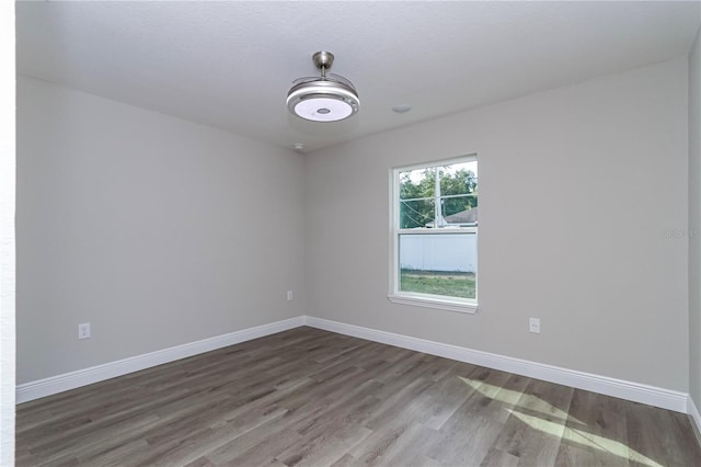 spare room with wood-type flooring