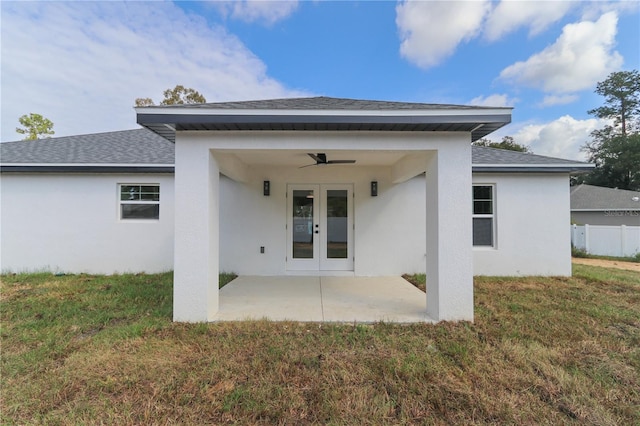 back of property with ceiling fan, a patio area, and a lawn