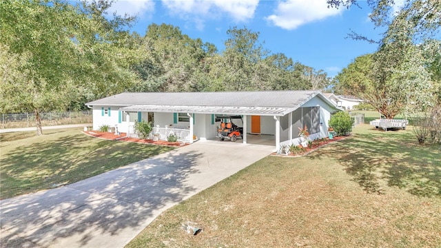 single story home featuring a carport, a porch, and a front lawn