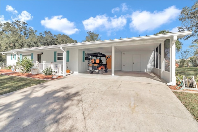 ranch-style house with a porch and a carport