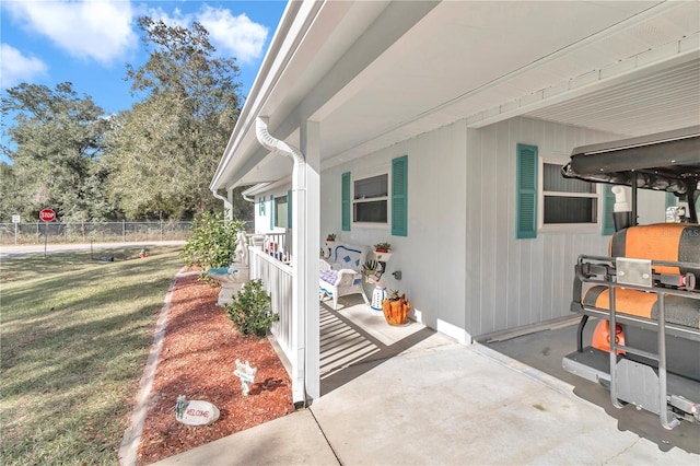 view of home's exterior with a patio area and a yard