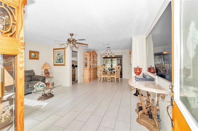 living room with ceiling fan and a textured ceiling