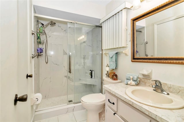 bathroom with tile patterned floors, vanity, toilet, and walk in shower