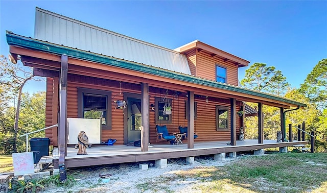 back of property featuring covered porch