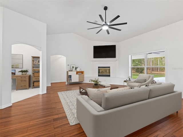 living room with ceiling fan, lofted ceiling, and hardwood / wood-style flooring