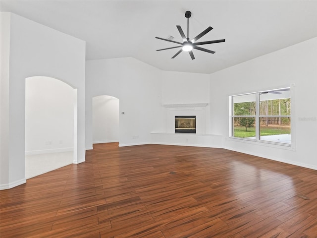 unfurnished living room featuring lofted ceiling, ceiling fan, and dark hardwood / wood-style floors