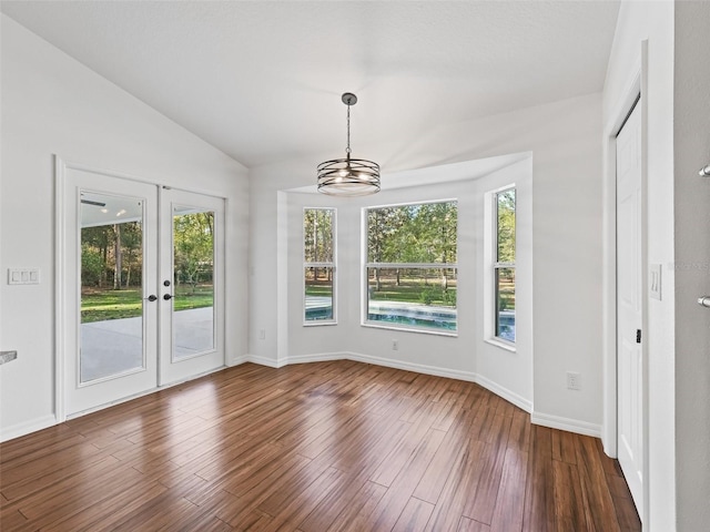 interior space with a notable chandelier, lofted ceiling, and french doors