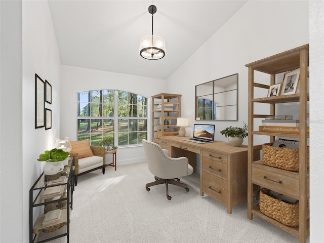 carpeted home office featuring lofted ceiling