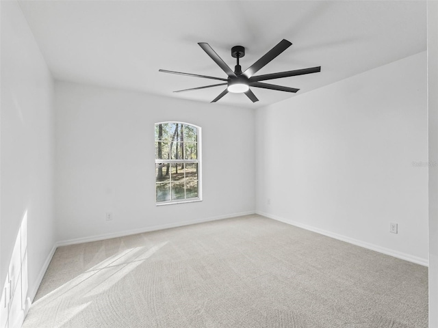 spare room with ceiling fan and light colored carpet