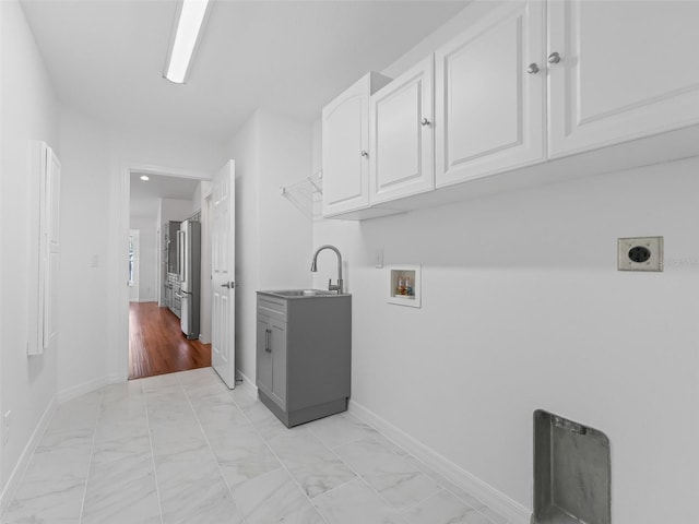 washroom featuring cabinets, hookup for a washing machine, light wood-type flooring, electric dryer hookup, and sink