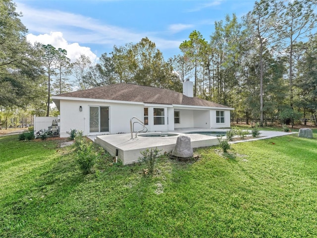 back of house with a fenced in pool, a yard, and a patio