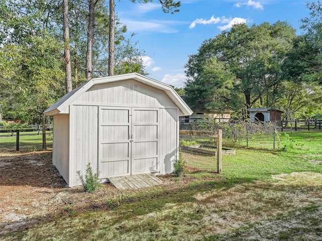 view of outbuilding with a yard