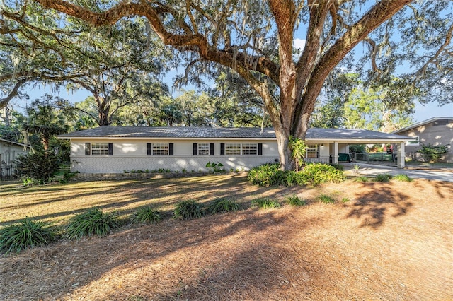 ranch-style home with a front yard and a carport