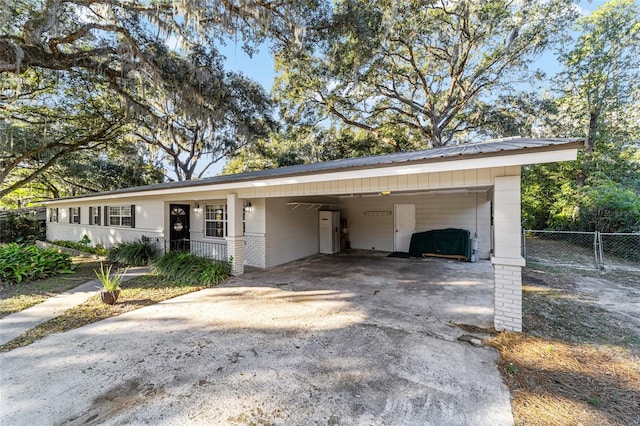 ranch-style house featuring a carport