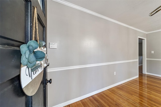 interior space featuring hardwood / wood-style flooring and ornamental molding