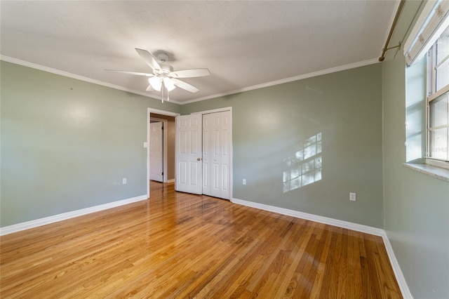 unfurnished bedroom featuring ceiling fan, crown molding, and light hardwood / wood-style floors