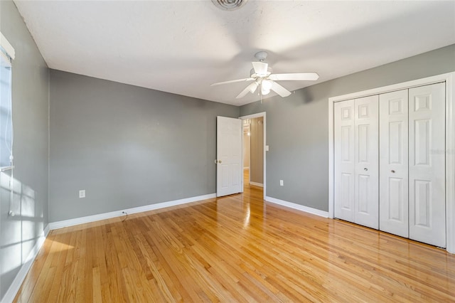 unfurnished bedroom featuring a closet, ceiling fan, and hardwood / wood-style floors