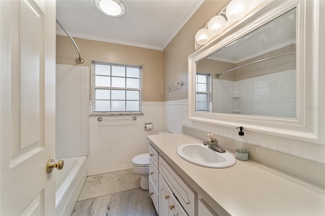 full bathroom with tiled shower / bath combo, vanity, toilet, and ornamental molding