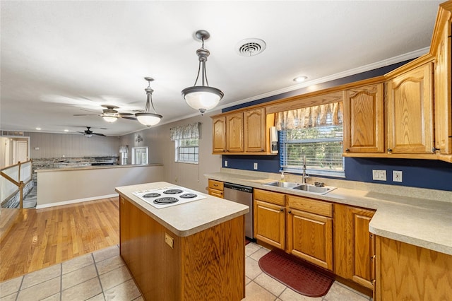 kitchen with light wood-type flooring, decorative light fixtures, a kitchen island, and a healthy amount of sunlight