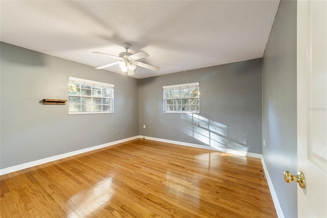 unfurnished room with ceiling fan, light hardwood / wood-style flooring, and a healthy amount of sunlight