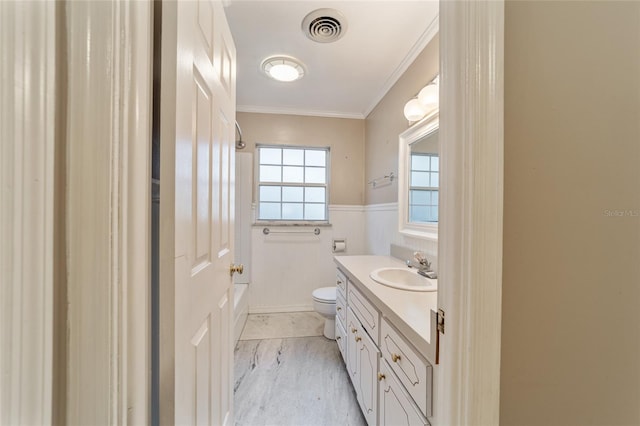 bathroom featuring vanity, toilet, and ornamental molding