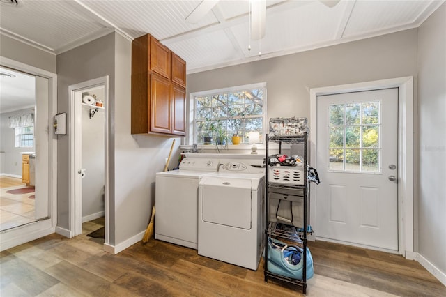 laundry room featuring hardwood / wood-style floors, cabinets, and plenty of natural light