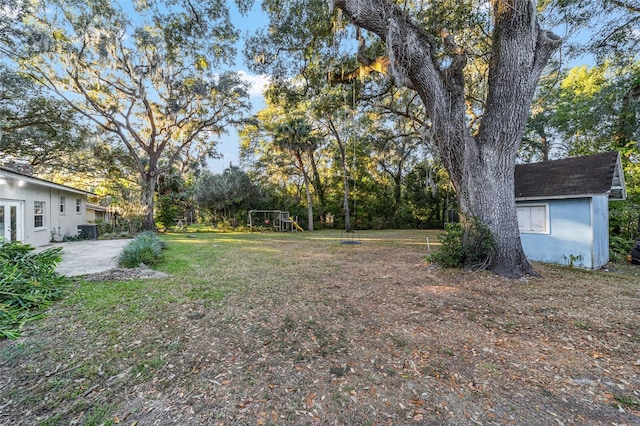 view of yard featuring a playground and a patio