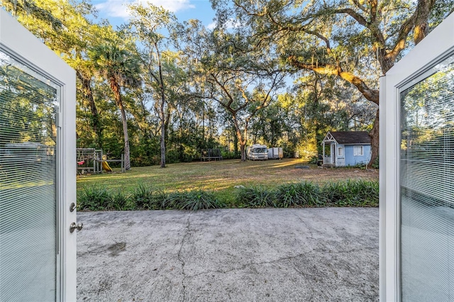 view of patio featuring a shed and a playground