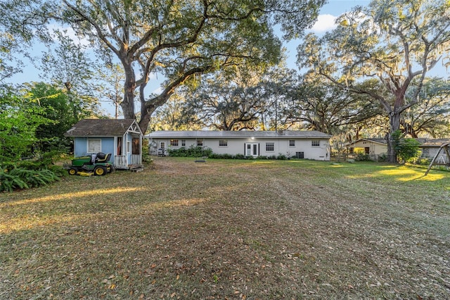 exterior space with an outbuilding and a front lawn