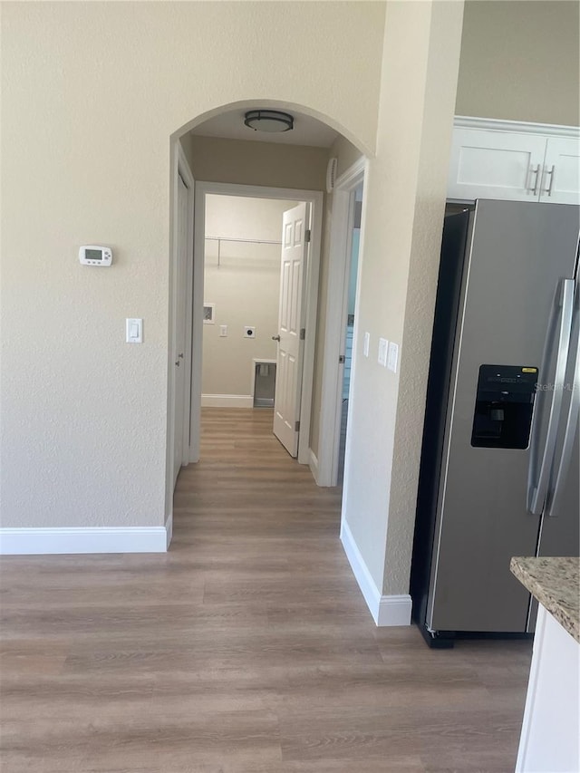 hallway with light hardwood / wood-style floors