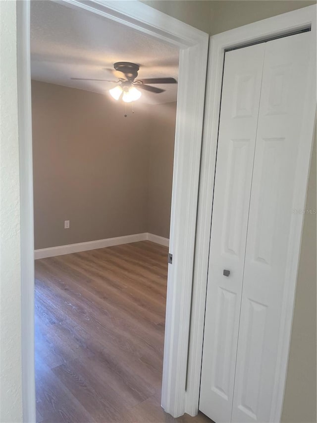 unfurnished bedroom with a closet, ceiling fan, and hardwood / wood-style floors