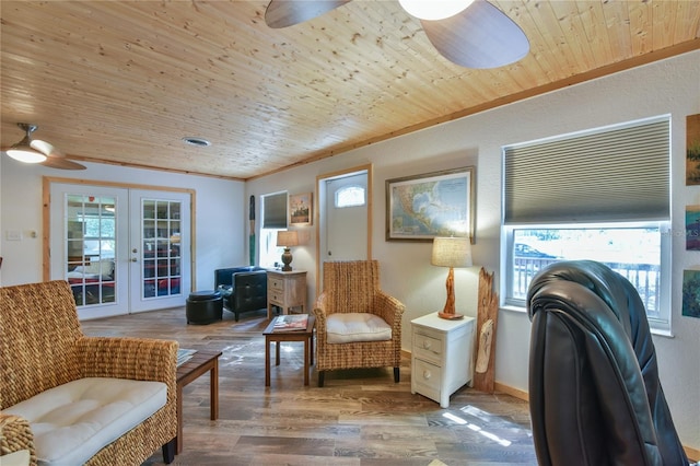 living area featuring french doors, ceiling fan, crown molding, hardwood / wood-style flooring, and wooden ceiling