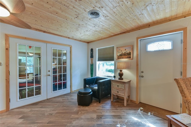 foyer featuring wood-type flooring, french doors, a healthy amount of sunlight, and wood ceiling