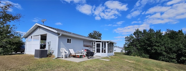 rear view of property with a lawn, a sunroom, a patio area, and cooling unit