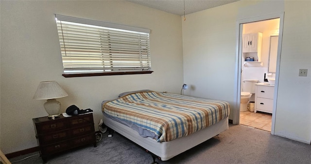 carpeted bedroom with ensuite bath