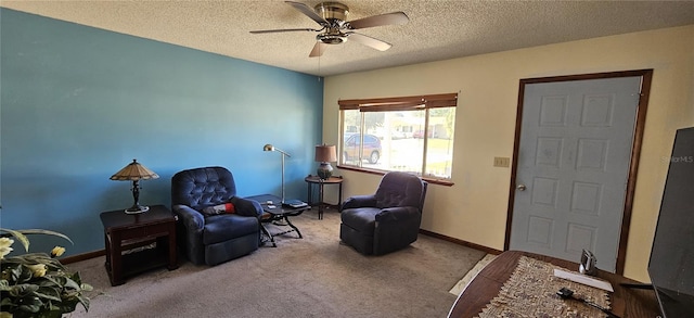 living area featuring a textured ceiling, light colored carpet, and ceiling fan